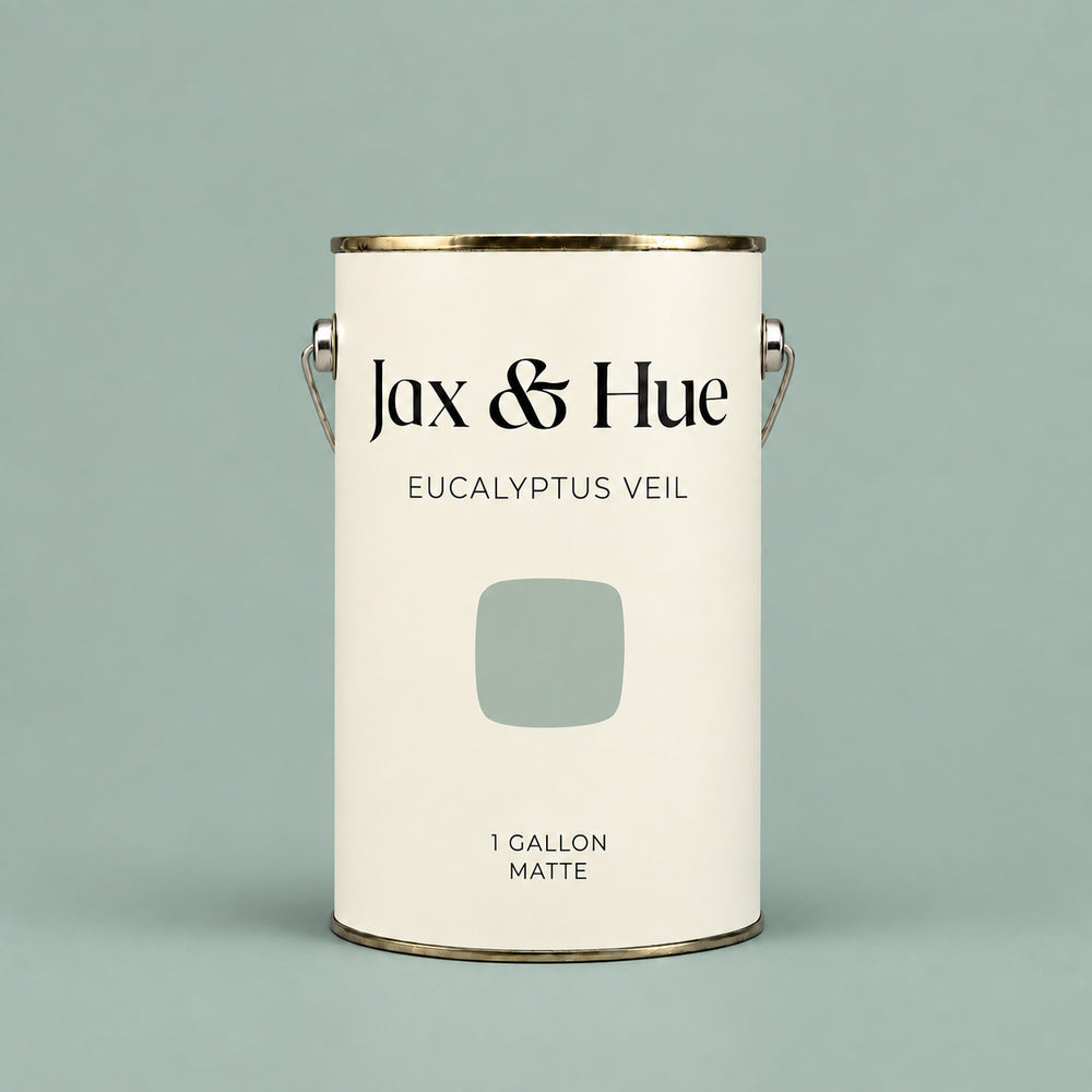 Jax & Hue Eucalyptus Veil soft sage green matte paint gallon on a matching pale green background.