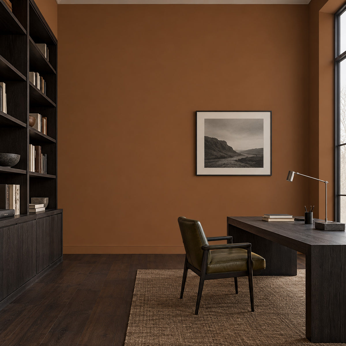 Bridle Clay muted reddish brown walls in a modern home office with dark shelving, a wood desk, and an olive chair.