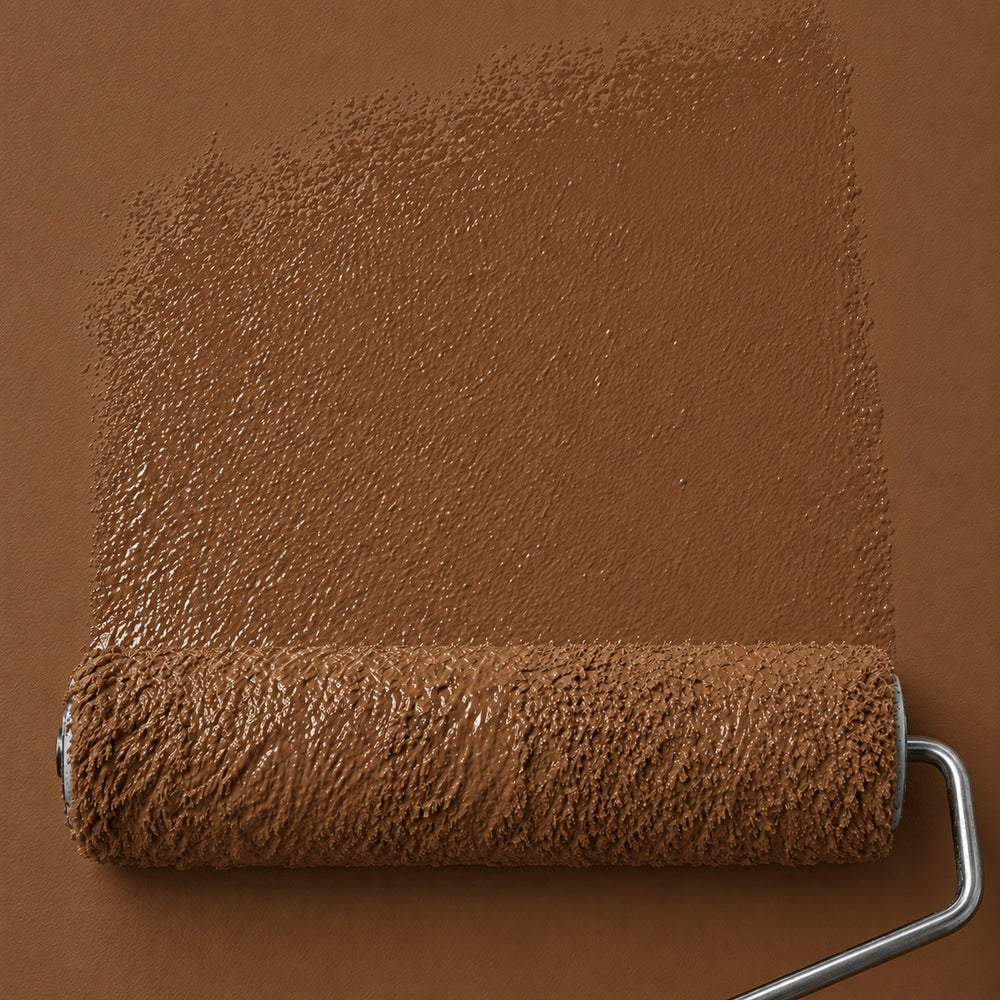 Roller applying Bridle Clay deep earthy brown matte paint to a wall, showing the rich reddish brown color and fresh paint texture.