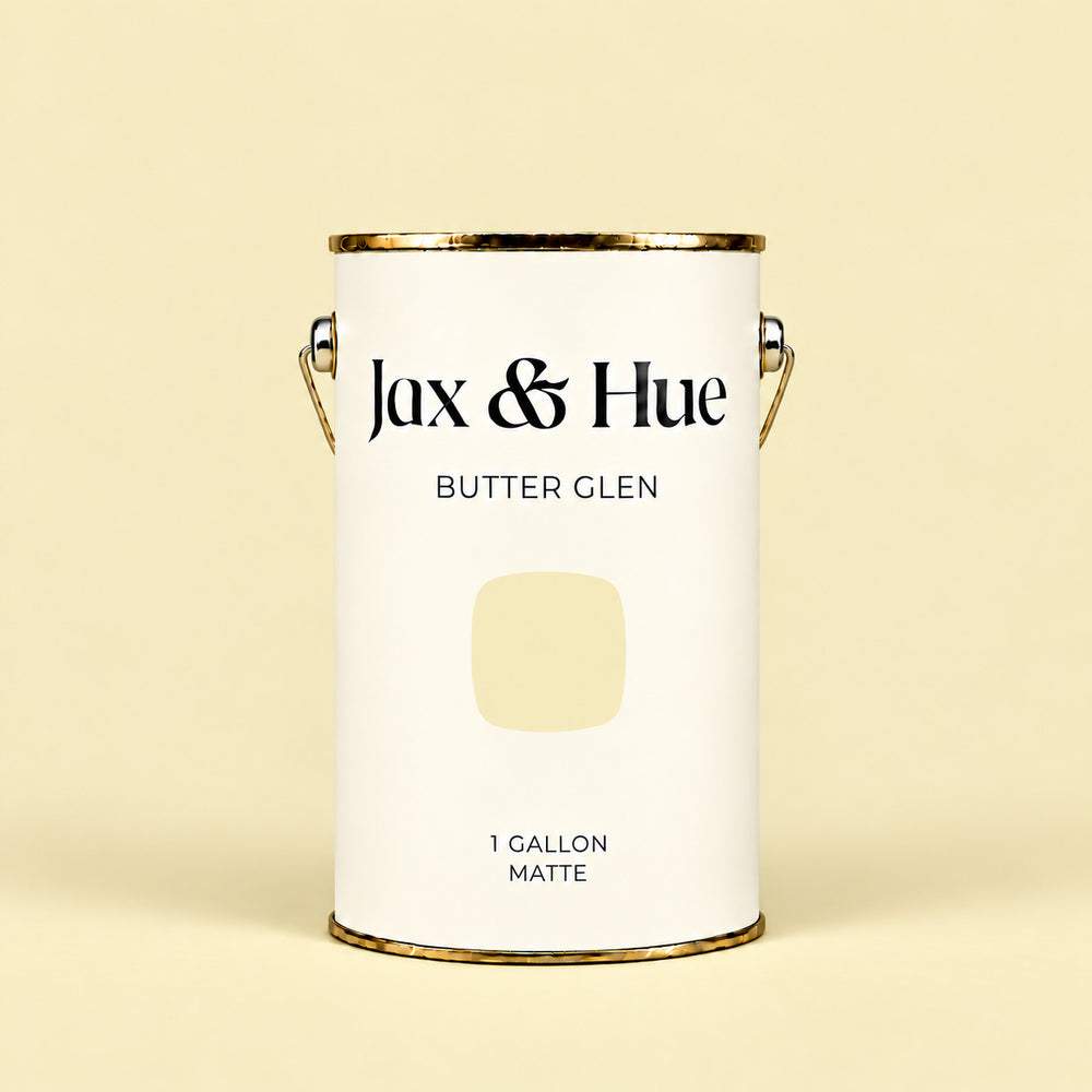 Jax & Hue Butter Glen warm butter yellow matte paint gallon on a matching yellow background.