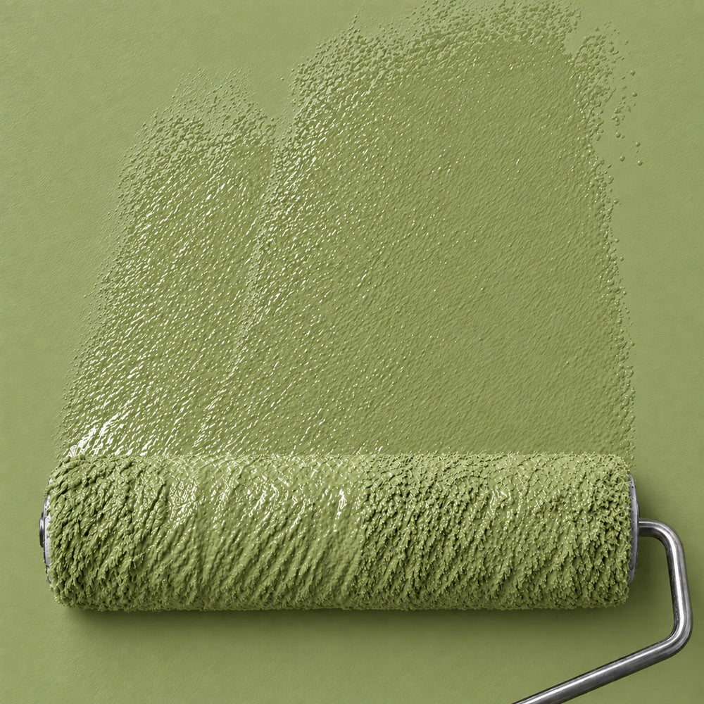 Paint roller spreading Citron Basil fresh yellow-green paint across a matching wall.