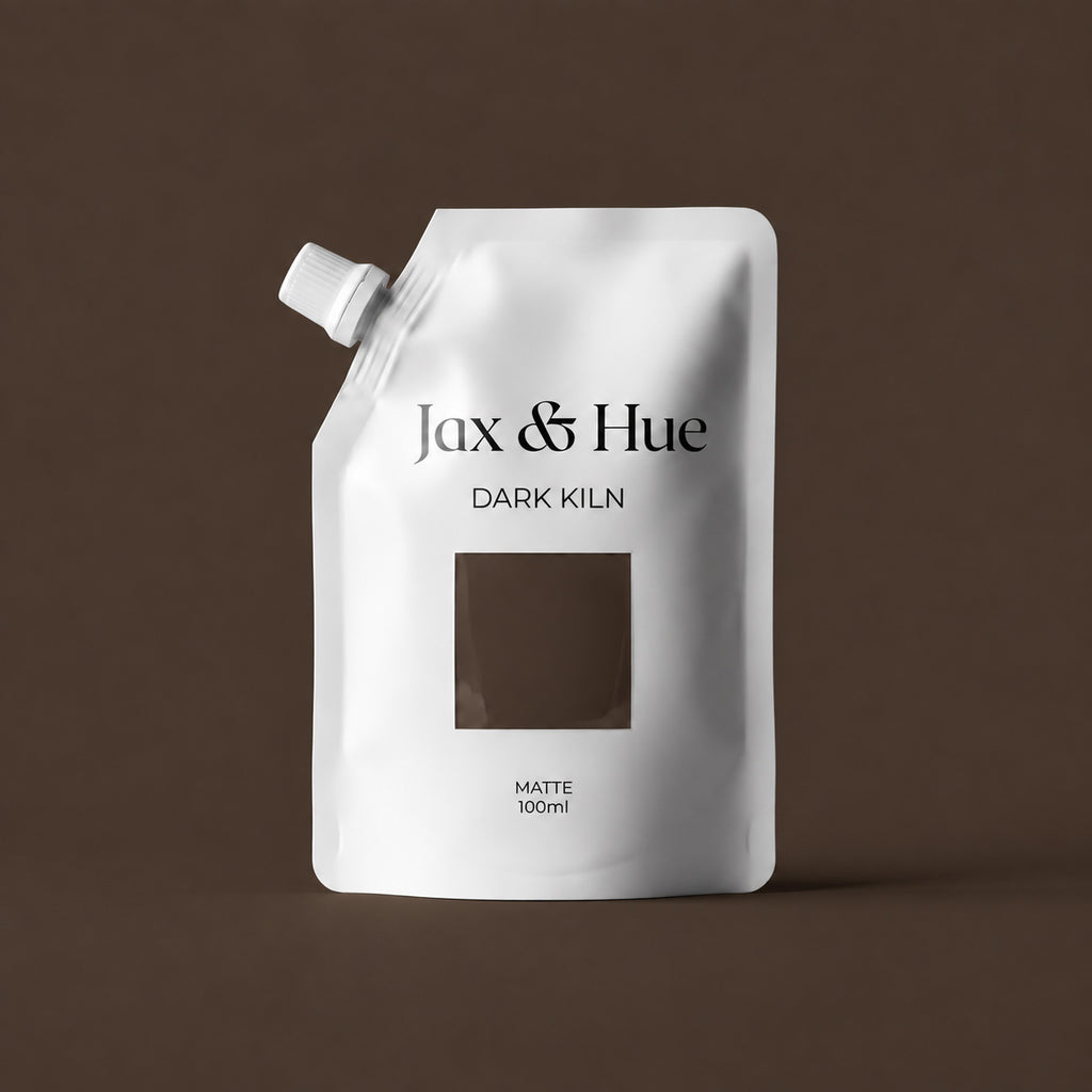 Jax & Hue Dark Kiln 100 ml Color Tester pouch with a deep warm chocolate brown paint swatch against a matching brown backdrop.