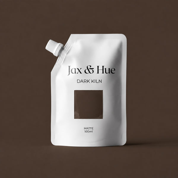 Jax & Hue Dark Kiln 100 ml Color Tester pouch with a deep warm chocolate brown paint swatch against a matching brown backdrop.