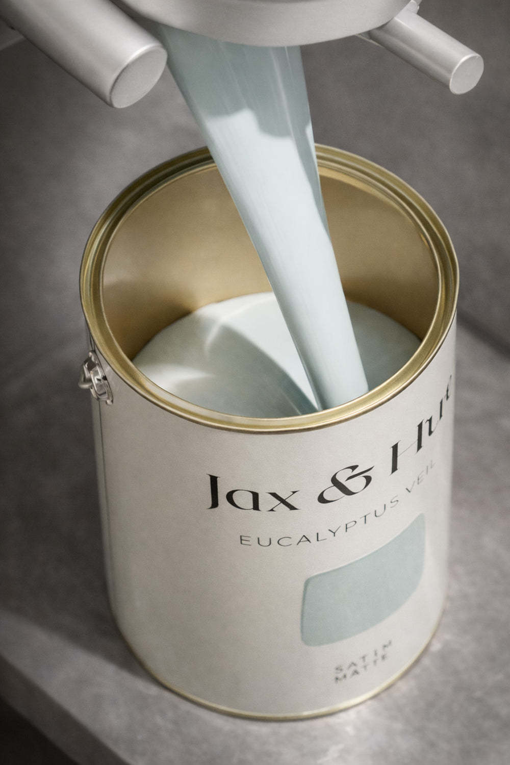 creamy eucalyptus tinted paint being poured