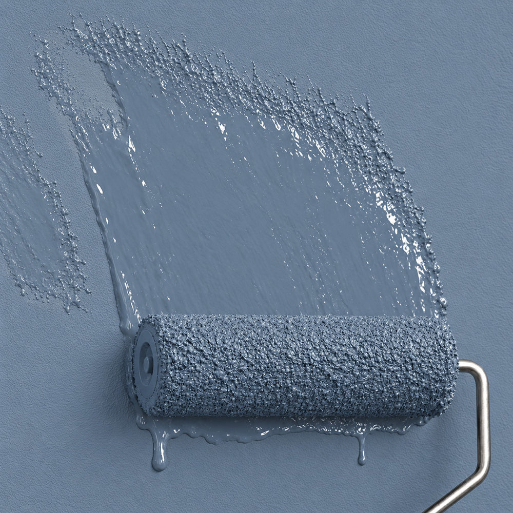 Paint roller spreading Moonstone Bay muted blue-grey paint across a matching wall.