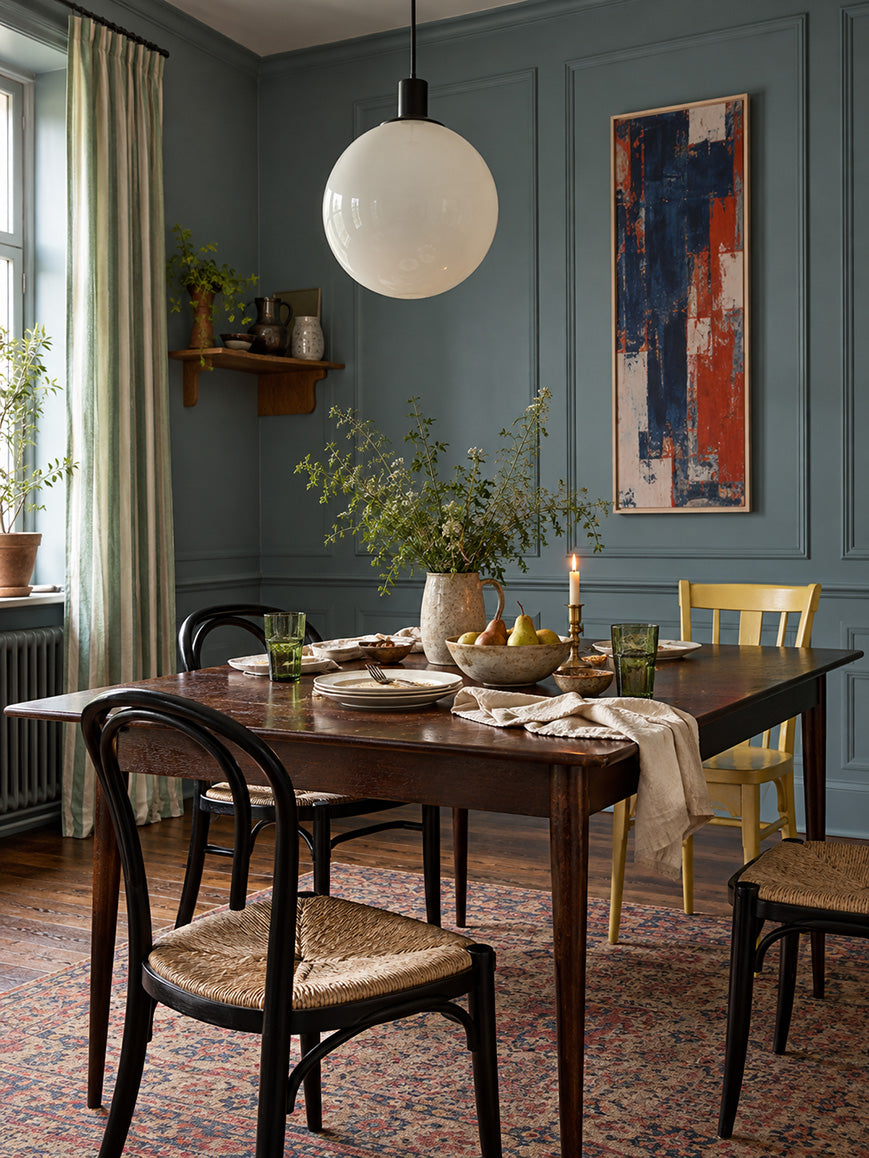 Salt Fjord muted blue-green grey paint in a dining room with vintage bentwood chairs and a globe pendant.