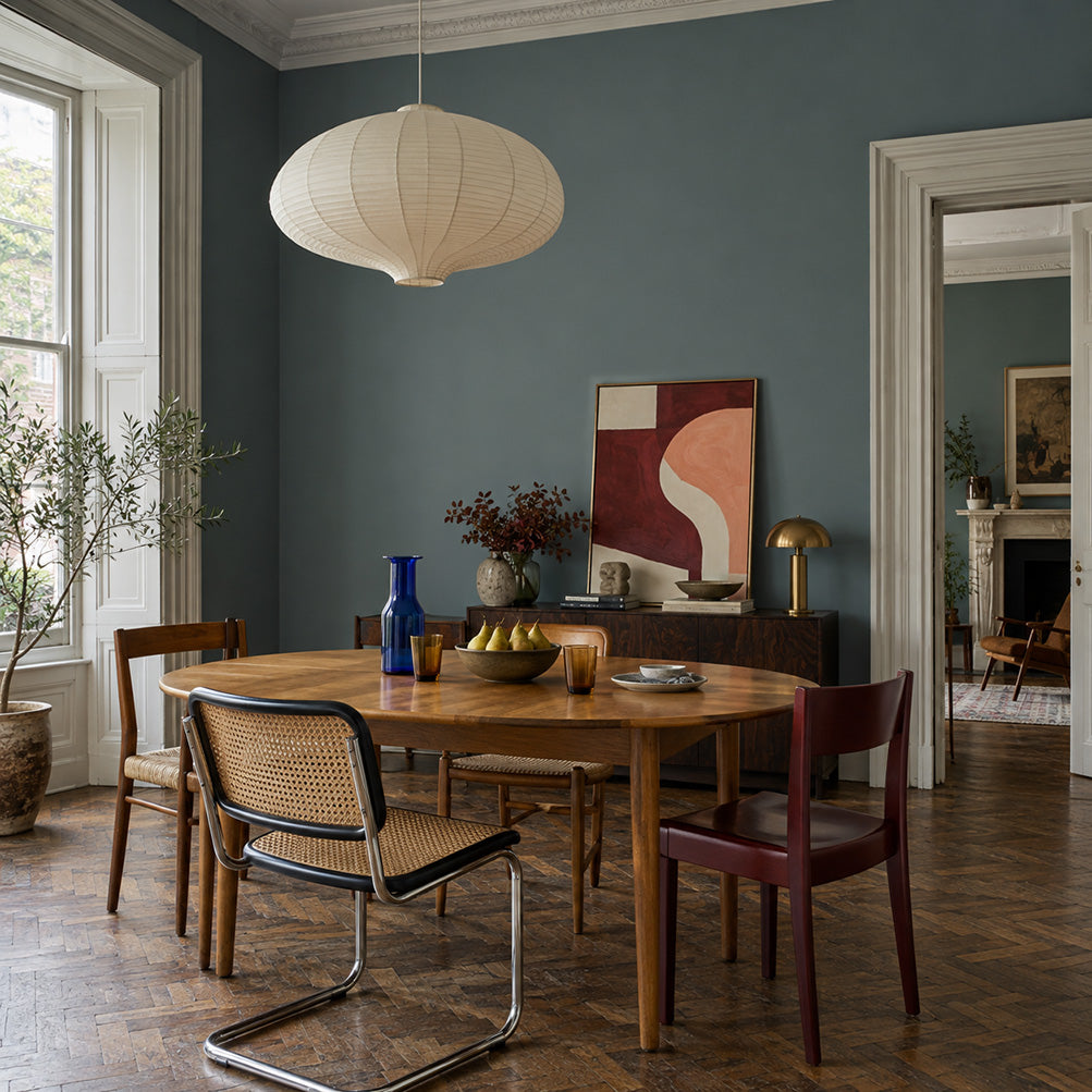 Salt Fjord blue-green grey dining room walls with an oak table, mismatched chairs, and a paper pendant.