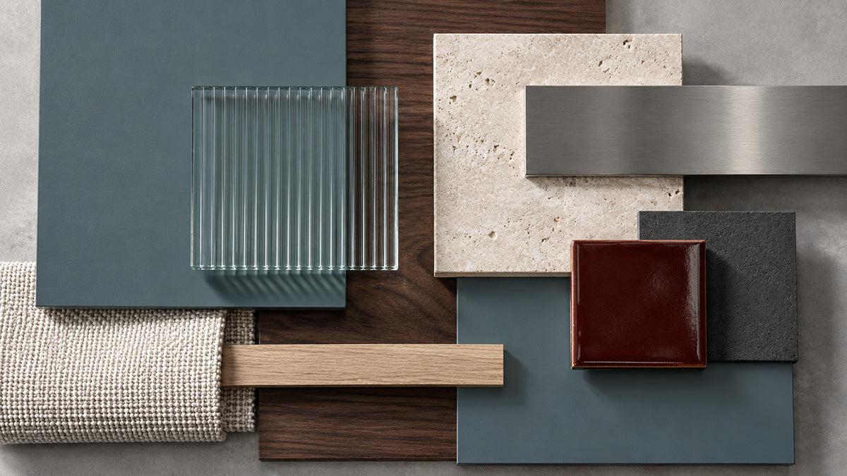 Salt Fjord blue-green grey paint samples layered with walnut, ribbed glass, brushed steel, and oxblood tile.