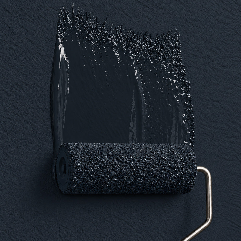 Paint roller spreading Stillwater Ink deep inky blue-black paint across a matching dark wall.