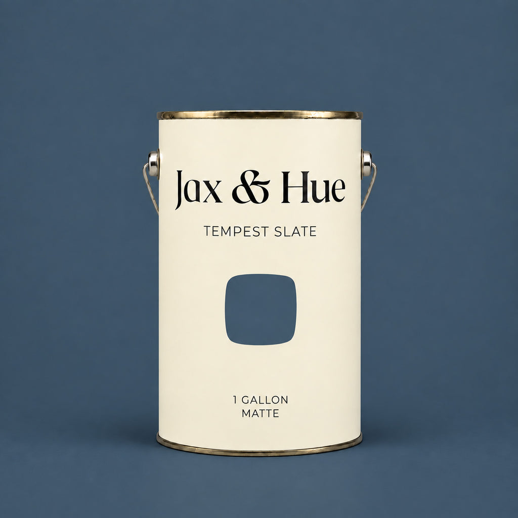 Jax & Hue Tempest Slate gallon of deep slate blue-gray interior paint against a matching backdrop