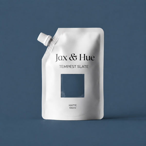 Jax & Hue Tempest Slate tester pouch of deep slate blue-gray interior paint against a matching backdrop