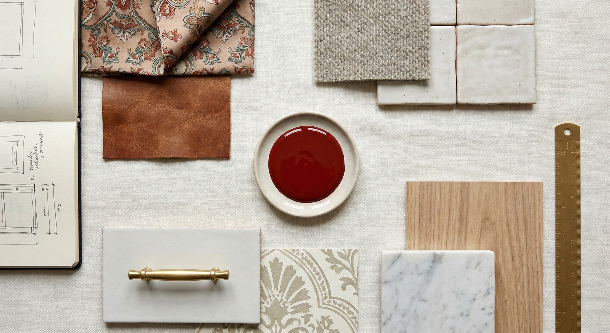 Collection of materials including fabric, leather, paint, and tiles on a white surface.