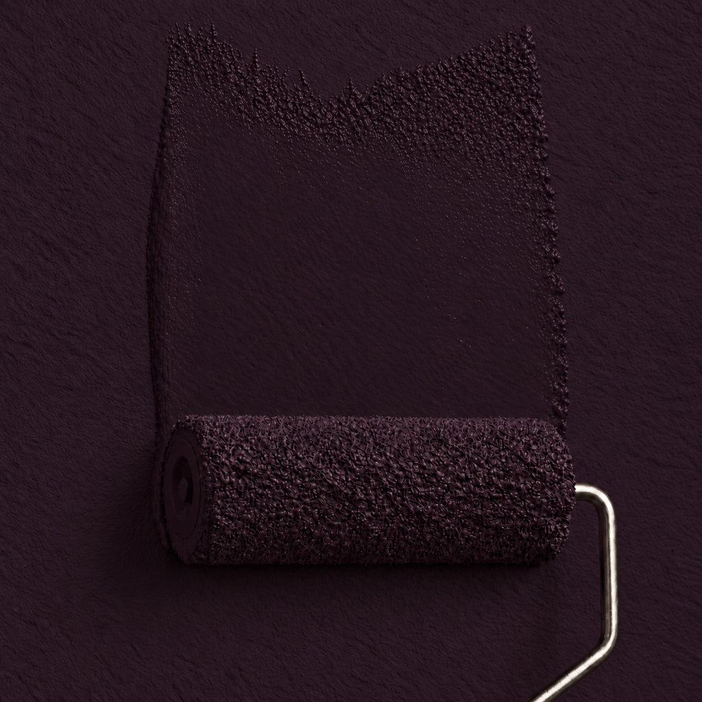 Paint roller spreading Violet Carriage deep plum purple paint across a matching dark purple wall.